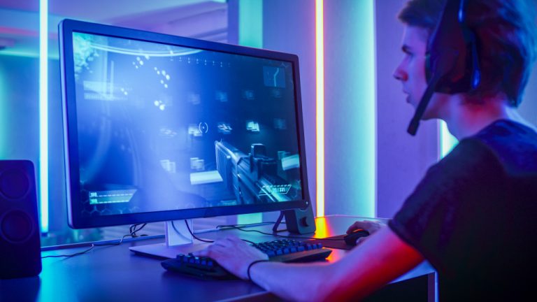 gamer playing fps game in his gaming setup