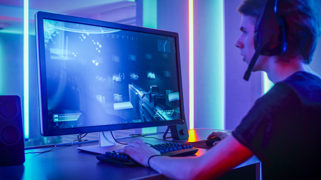 gamer playing fps game in his gaming setup