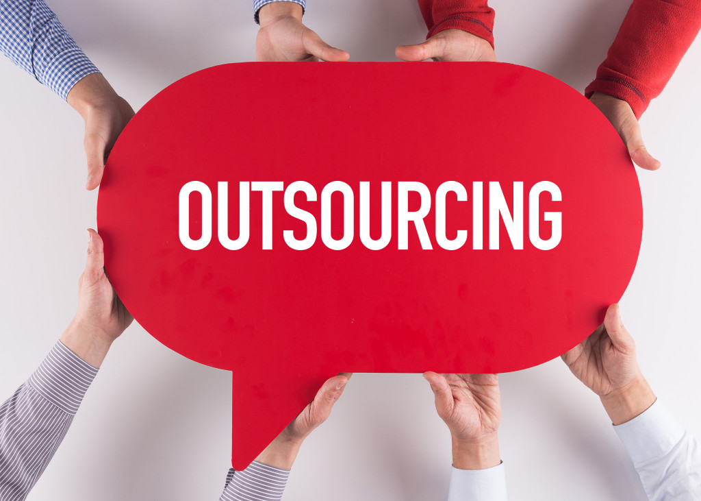 the word outsourcing in a red bubble